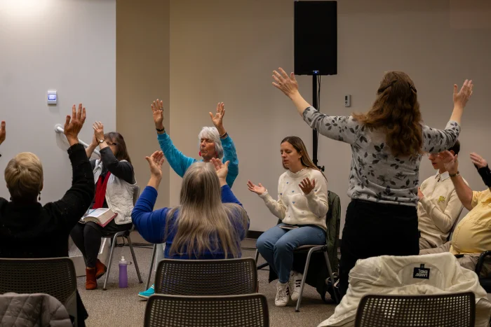 Prayer group raising their hands.