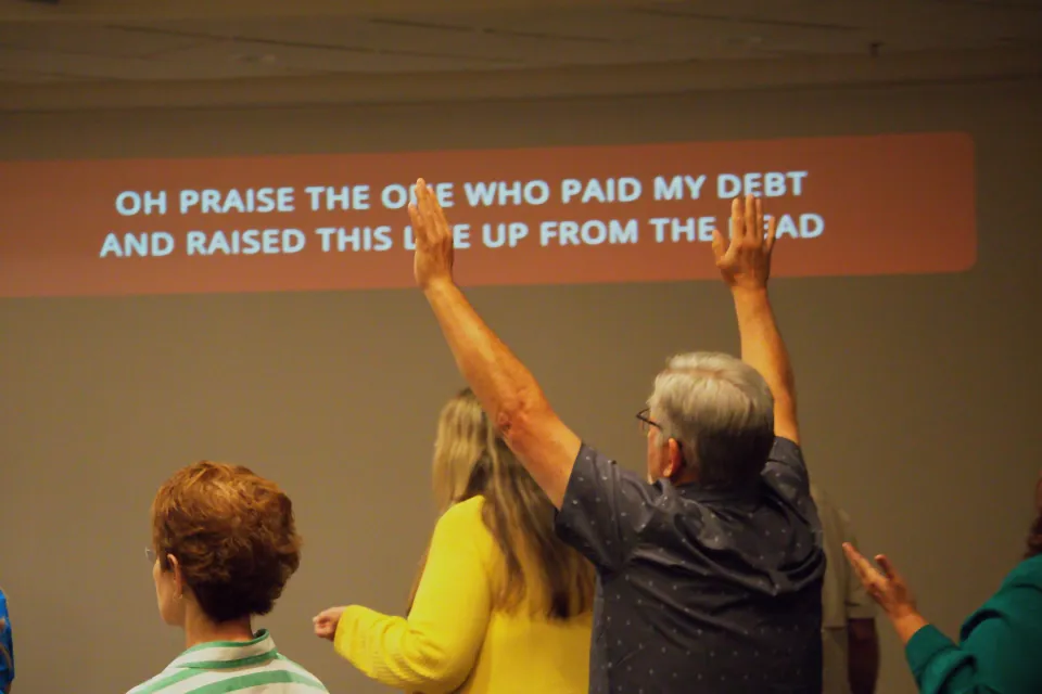 People's hands raised during worship.