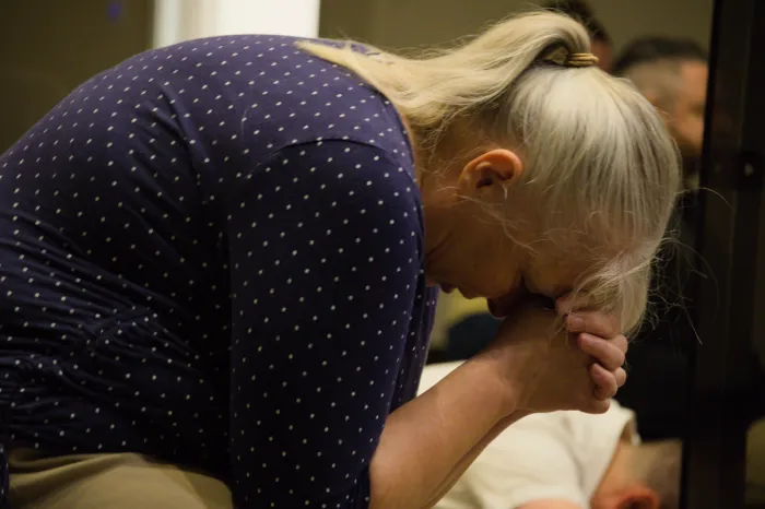 A women in deep prayer.