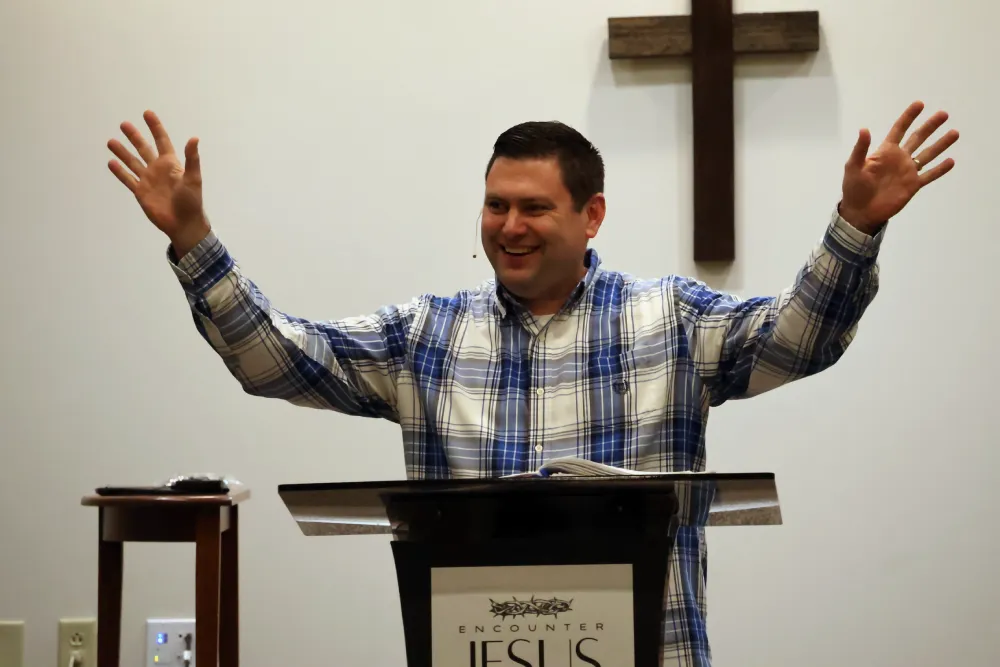 Pastor Tim Bright preaching and smiling.