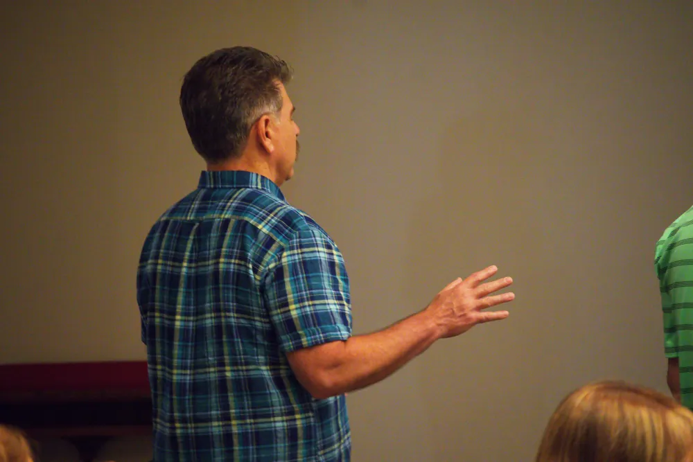 A man worshiping with his hands raised.